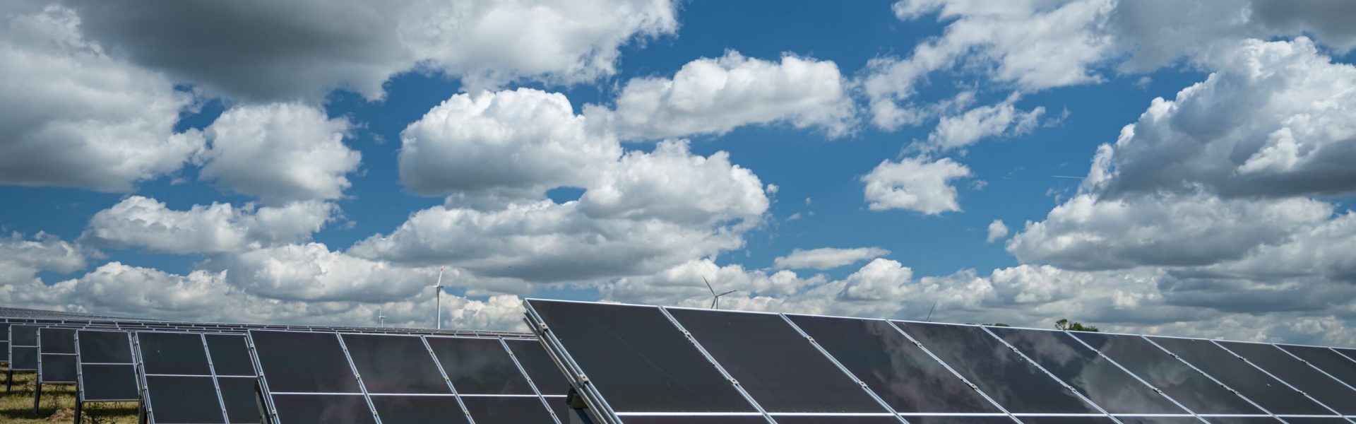 The solar panels used for renewable energy on the field under the sky full of clouds